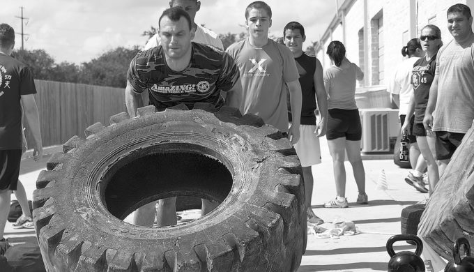 Fitness dude flipping tires.