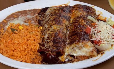 Enchiladas with a side of ubiquitous rice and beans are common Tex-Mex cuisine fare