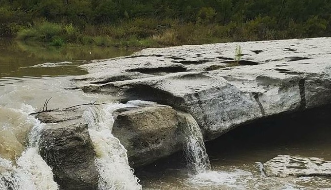 The falls of McKinney Falls Park, one of the Texas Hill Country state parks you must visit this fall