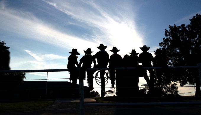 cowboys on a fence