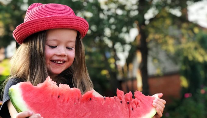 little-girl-eats-watermelon-and-smiles_t20_pxvWYd